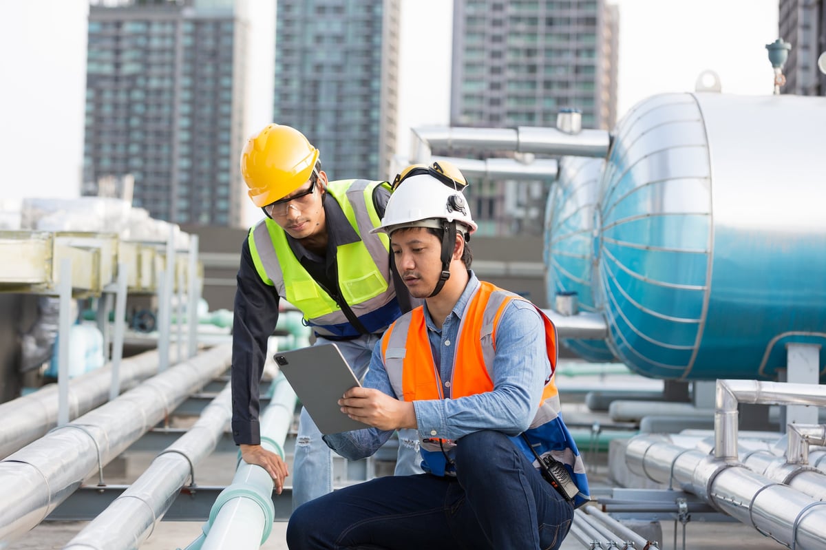 HVAC team collaborating on a service call process at a construction site