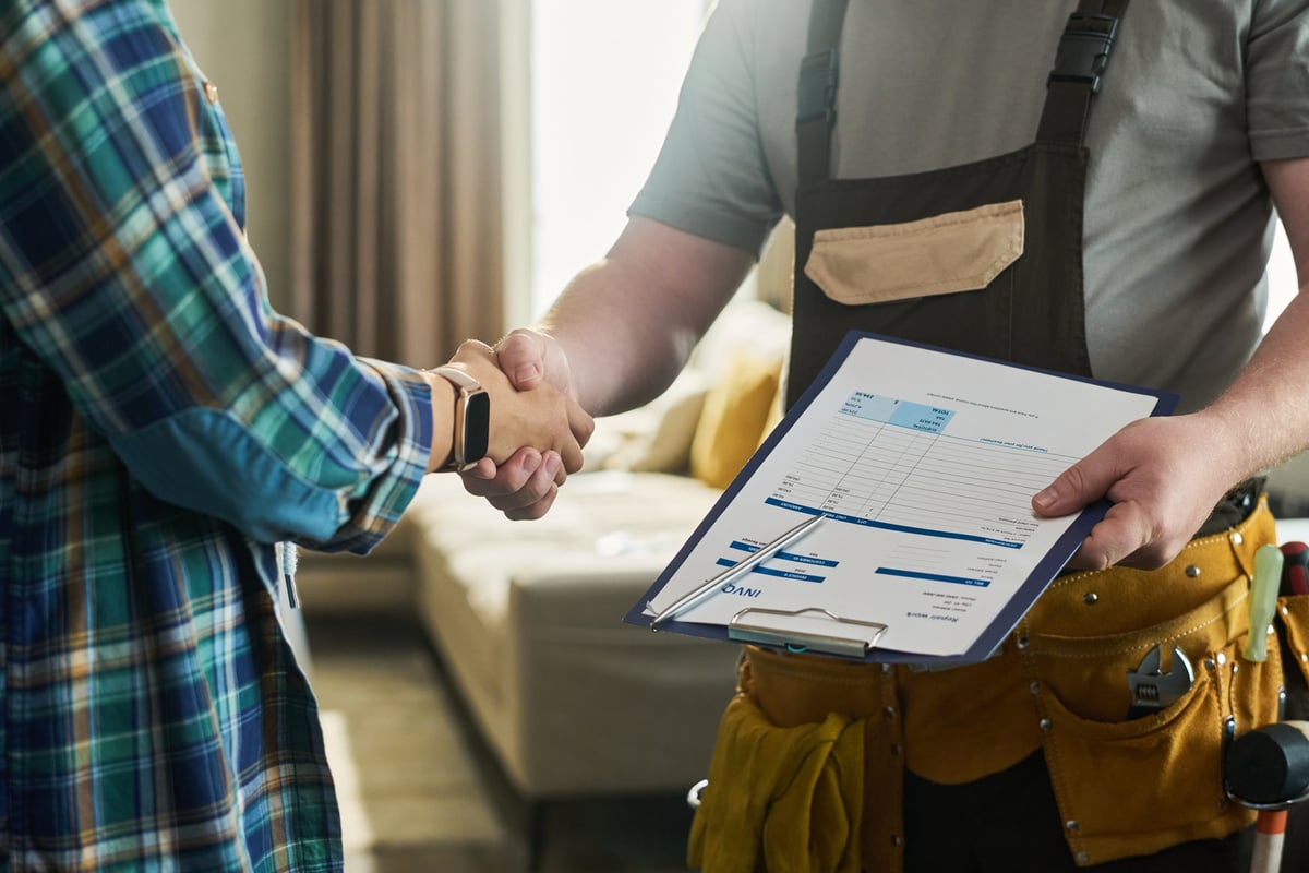 HVAC technician shaking hands with a homeowner, confirming service completion and building customer trust
