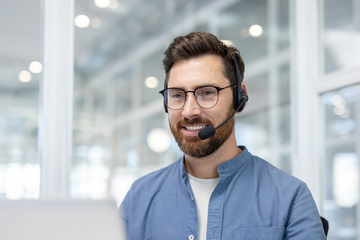 CSR or dispatcher in a professional office setting, representing helpful communication and professional customer support for HVAC service calls